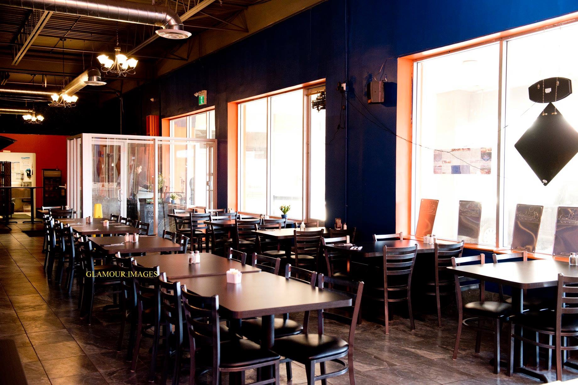Dining room at Blue Diamond Bar & Grill with rows of tables beside sunlit windows